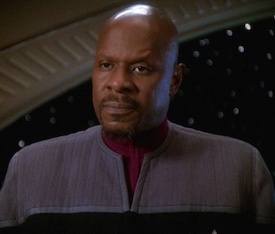 Black, male, bald starship captain.