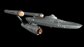 Starship with a saucer section and two warp nacelles. The warp nacelles have reddish tips.